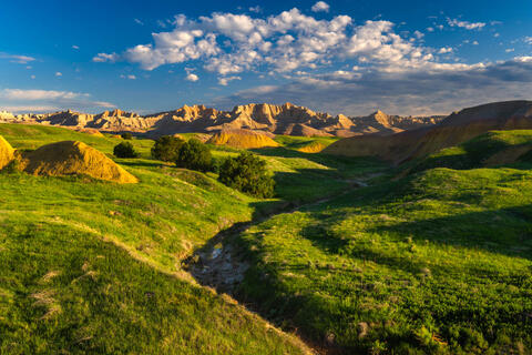 The lush and green grasslands of the Badlands prairie captured in late May in Badlands National Park, South Dakota. 