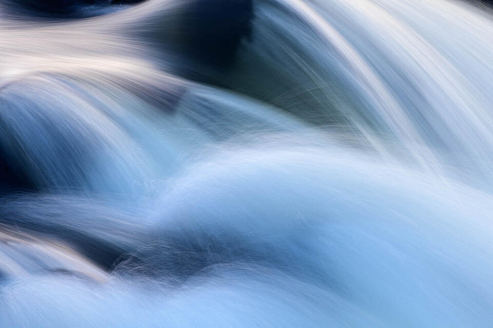 This photo depicts rushing water falling over rocks in Great Falls National Park, Virginia. 