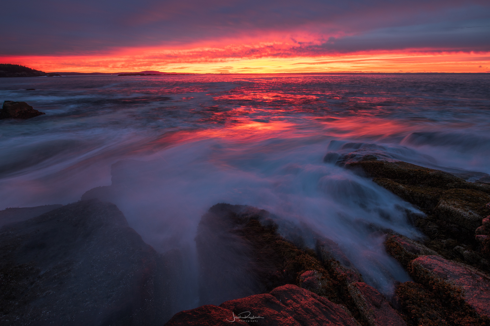 Breaking waves along Acadia's rugged coastline at sunrise.