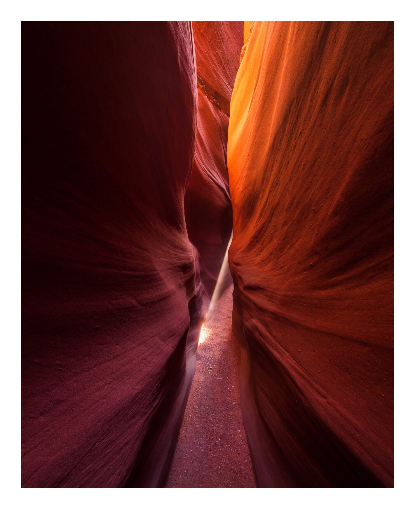 A small beam of light penetrates Spooky Canyon, one of the most narrow slot canyons in the southwest, in the Grand Staircase/...